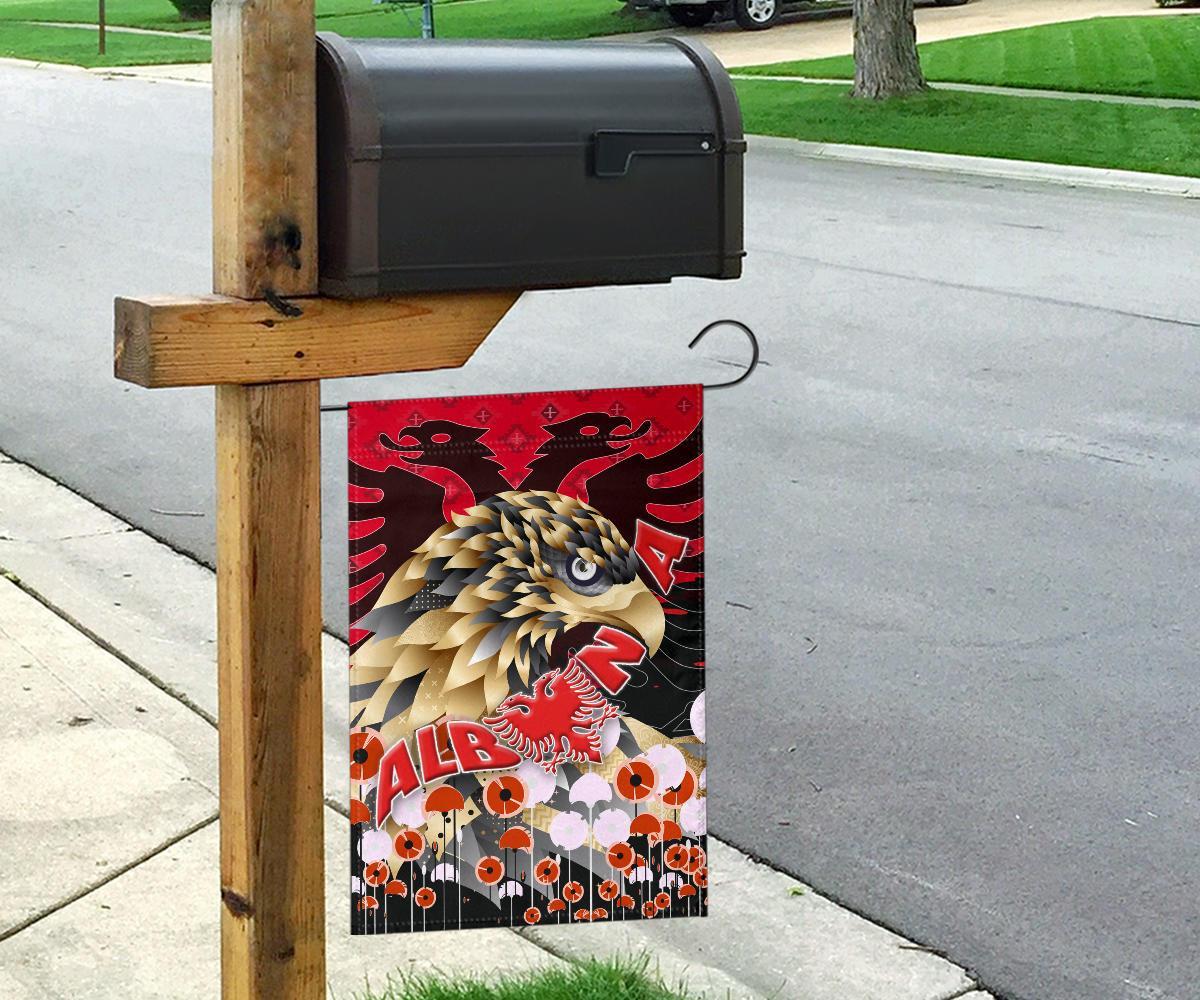 Red Albania garden flag on wooden post: eagle head and “ALB” with red lion