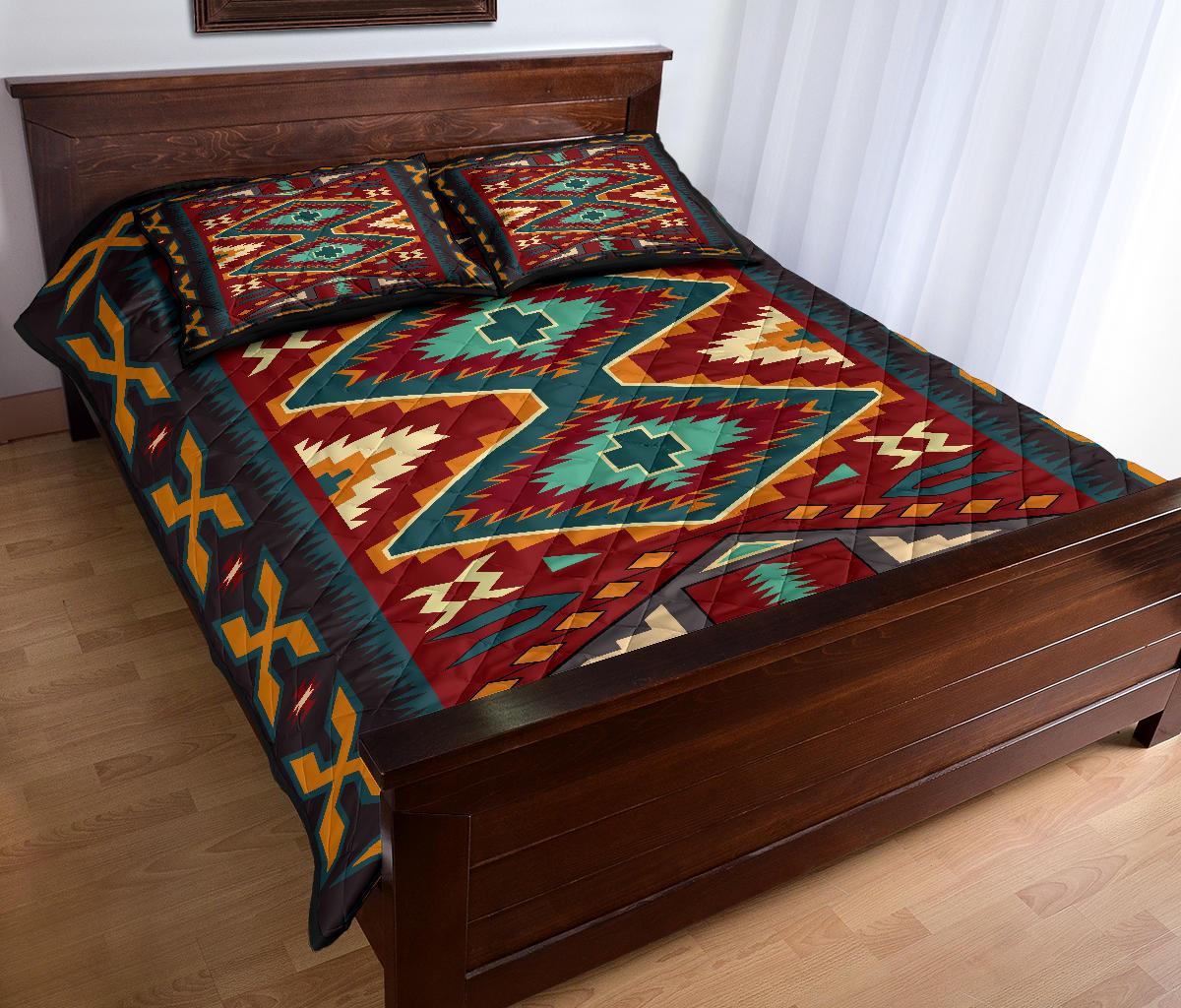 Native American quilt bed set in red and multicolor with large diamond center and teal border