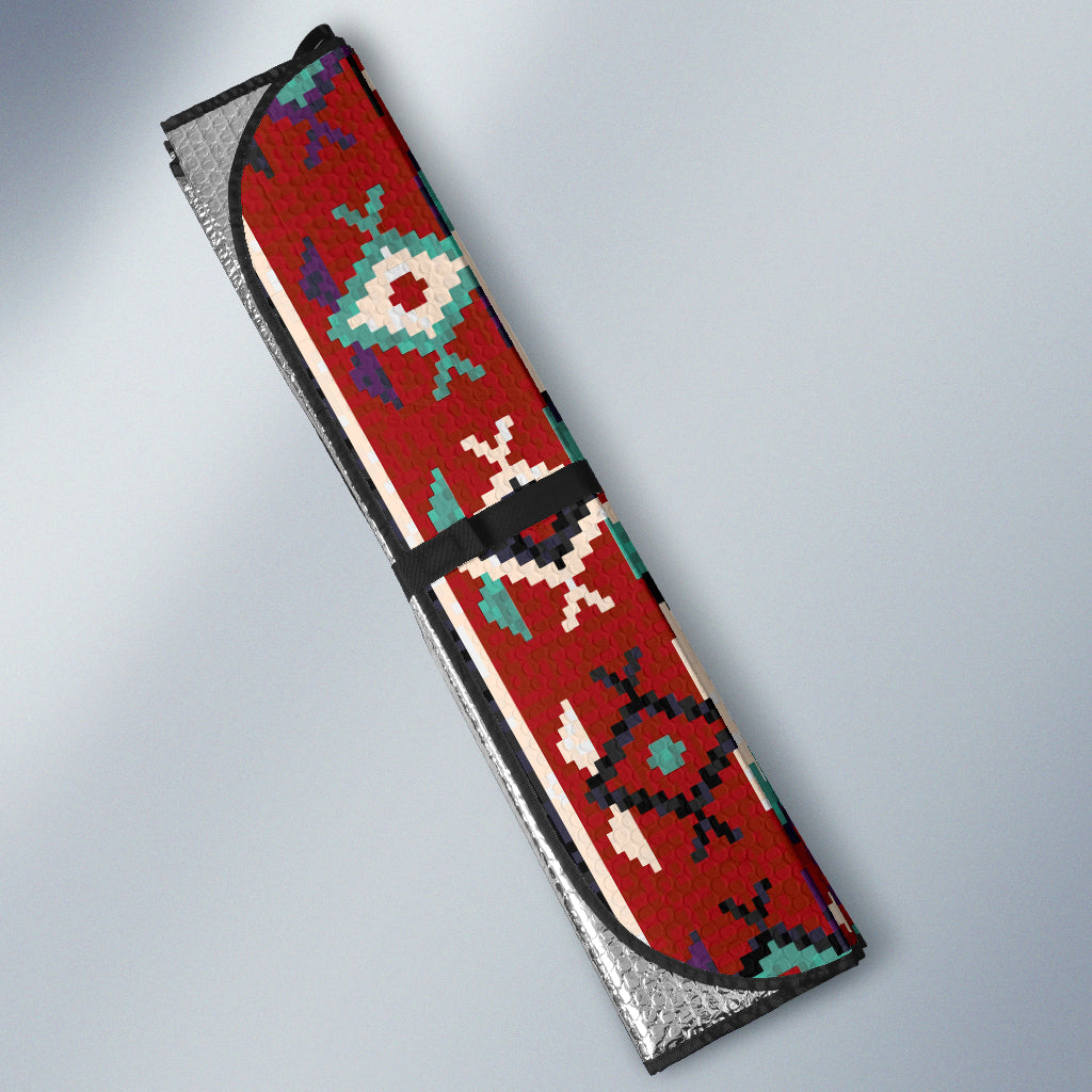 Folded red multicolor geometric auto sun shade with black trim and silver backing