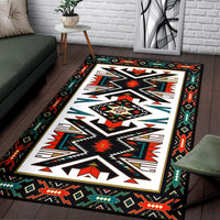 Native geometric area rug with black border and bold diamond and arrow motifs, rectangular