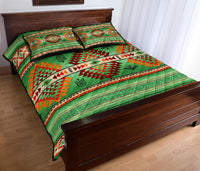 Green Native-style quilt bed set with red and orange geometric blocks and dreamcatcher icons