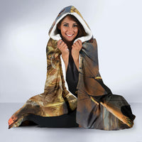 Hooded blanket worn with hood up, Native-style animals and figures print