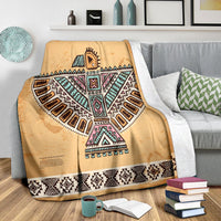 Brown throw blanket with Thunderbird motif and black-white patterned stripe hem