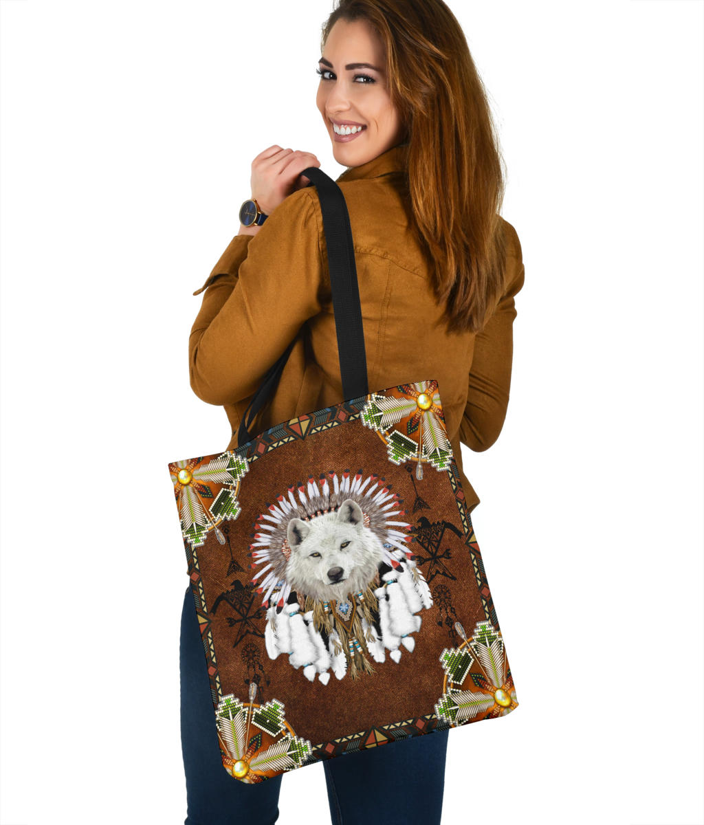 Wolf headdress tote bag with brown front, multicolor geometric trim, and gold corner accents