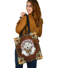 Wolf headdress tote bag with brown front, multicolor geometric trim, and gold corner accents