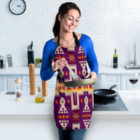 Purple apron with bold geometric print and black neck strap; worn over blue top
