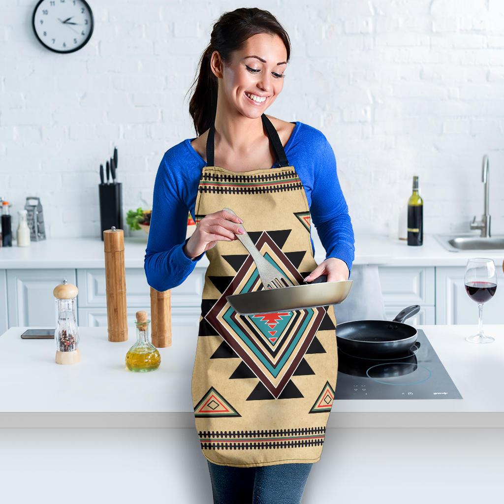Beige apron with southwest diamond print and black ties, worn over a blue shirt