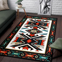 Colorful geometric area rug with large white diamond medallion on black, teal and red accents