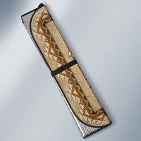 Tan auto sun shade with beaded stripe motif and black edge trim, folded