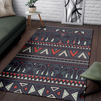 Close-up corner of dark tribal elephant rug with dotted swirls and geometric trim