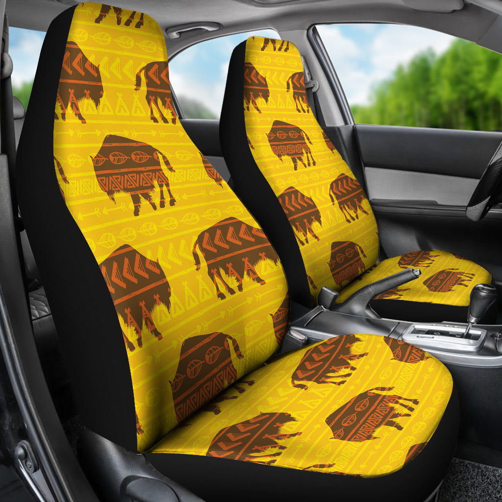 Installed yellow seat covers with black sides and repeating bison plus geometric pattern