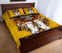 Snow owl quilt bed set with dreamcatcher motif and two yellow pillow shams on bed