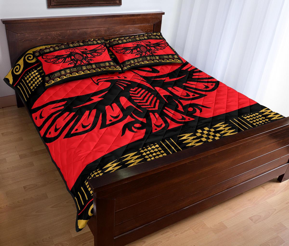 Red quilt bed set with eagle motif and gold zigzag band along the border
