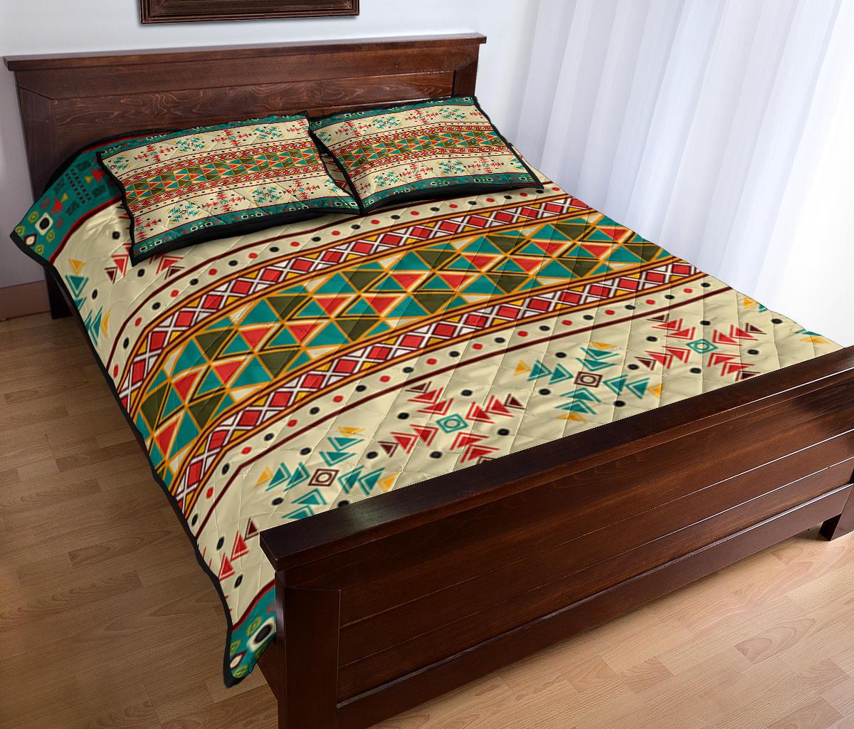 Geometric Native quilt bed set with cream, teal, and red diamond lattice across bed