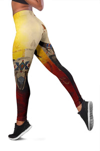 Multicolor leggings detail: bison head and wheel motifs, yellow/beige and red