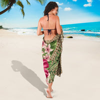 Back view Hawaiian sarong tied at waist, tan with pink plumeria and green leaf print