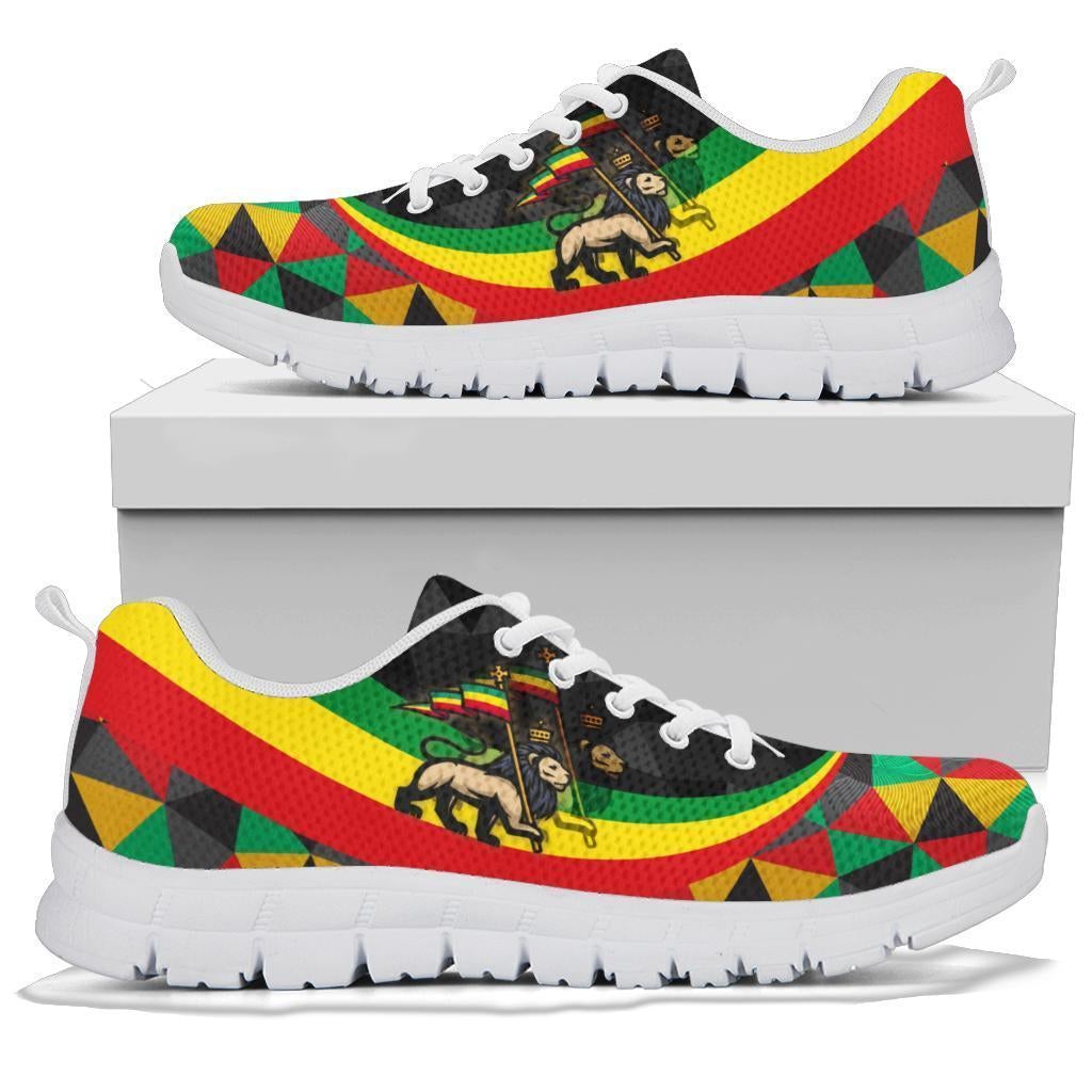 White-soled sneaker on box, rasta lion and flag-style multicolor geometric print