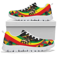 White-soled sneaker on box, rasta lion and flag-style multicolor geometric print