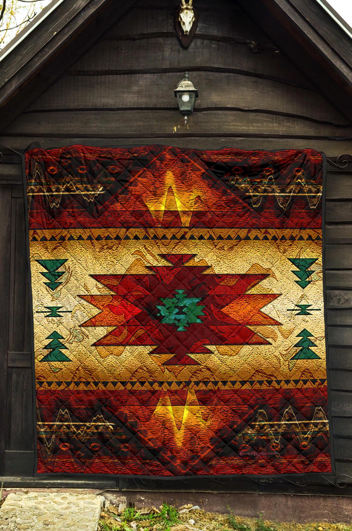 Quilt hung indoors: red top band with yellow center star, green motif details, dark edges