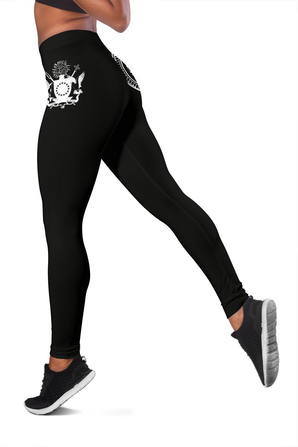 Black leggings with small white sunburst motif and swirl on thigh