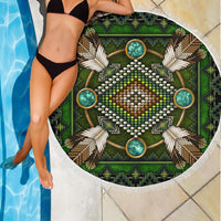 Green round beach blanket with white fringe, central sunburst mandala in beads