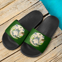 Pair of black slide sandals with green Totoro-themed straps