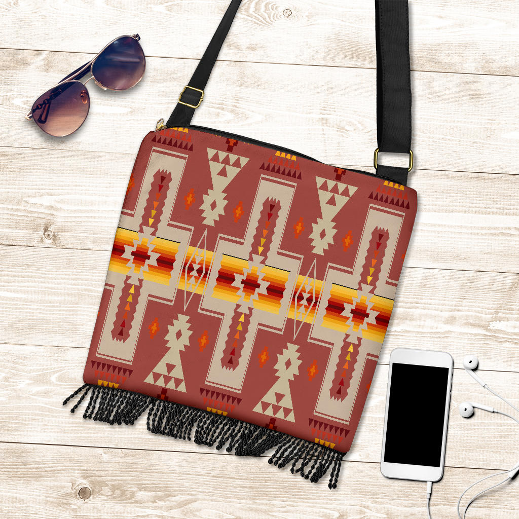 Multicolor geometric crossbody bag in red with black strap, gold buckle, and hanging fringe