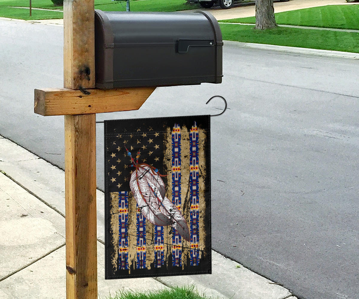 Feather Native American flag hanging from a yard post with stars and blue stripes