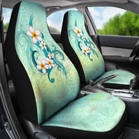 Front seats wearing turquoise Hawaiian plumeria covers with floral swirl design