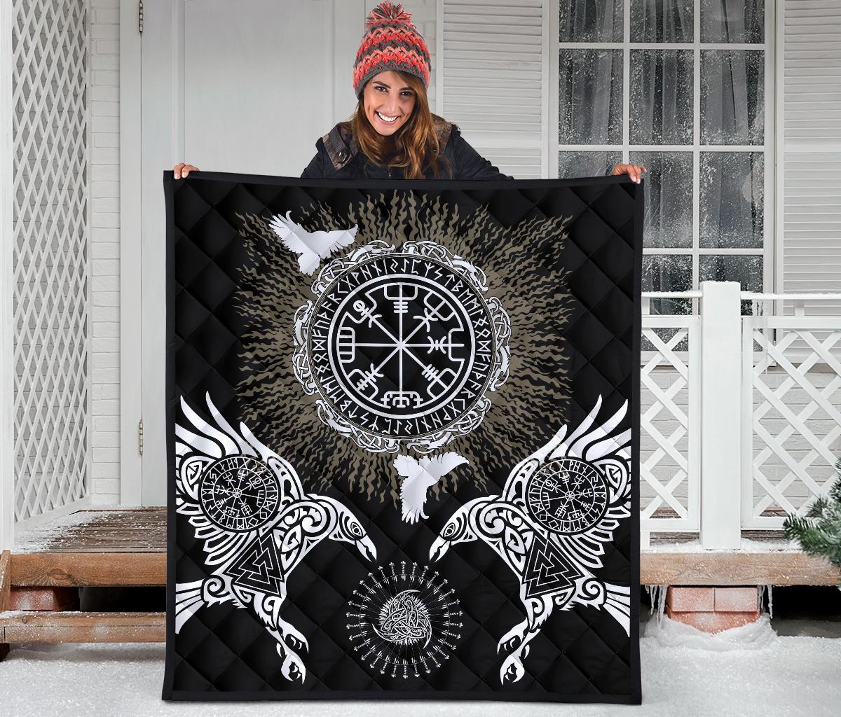 Black quilt held up outdoors showing central Valknut/Vegvisir emblem and two ravens