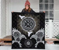 Black quilt held up outdoors showing central Valknut/Vegvisir emblem and two ravens