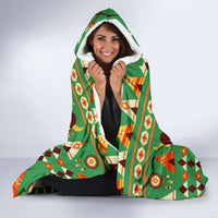 Green hooded blanket with multicolor tribal bison pattern and sherpa-like hood lining