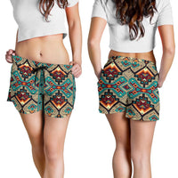 Women wearing tribal print drawstring shorts in teal, tan, and black; mid-thigh length