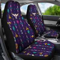 Two front seat covers in car: purple with bright cactus, arrow, and geometric icons