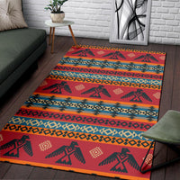 Red patterned area rug with blue and orange stripe bands and repeating animal icons