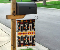 Black tribal design flag hanging from a wooden post, multicolor crosses and arrow shapes