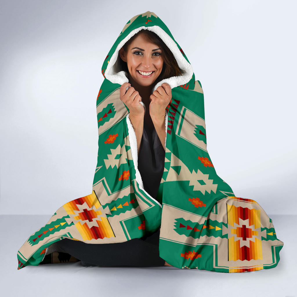 Hooded blanket with white sherpa-lined hood, green and multicolor geometric pattern