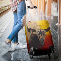 Bison skull luggage cover being pulled on suitcase with black corner wheels