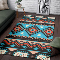 Tribal ethnic area rug with bold stripes, diamonds, and arrow shapes in teal