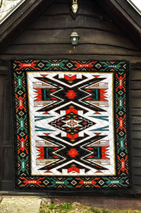 Geometric Native American-style quilt hanging on porch with black border and multicolor pattern