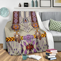 Purple patterned blanket with central star, beaded tassels, and large oval charm accents