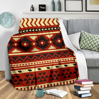 Red, black and cream ethnic geometric blanket draped over couch arm
