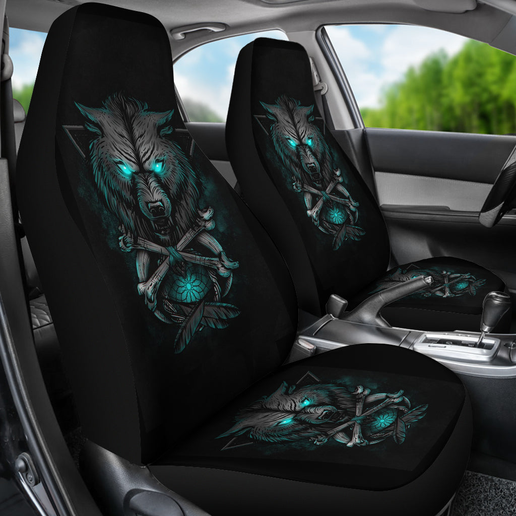 Black car seat covers showing a wolf with teal glowing eyes on backrest and seat