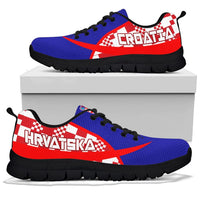 Blue and red Croatia sneakers with black tread sole, front view on display