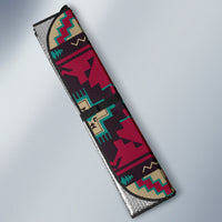 Rolled car sun shade side view with native geometric pattern in red, teal, and beige
