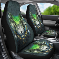 Angled car interior view of dark teal seat covers with green glow wolves and moon print