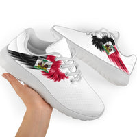 White sneakers with Haiti flag wing graphic; white laces and light sole, side view