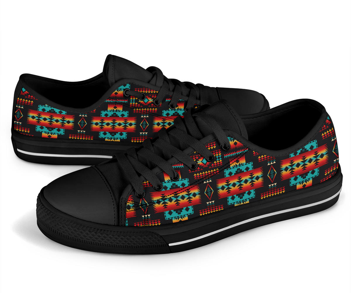 Low-top sneakers with black laces and multicolor Native tribal stripe print on the sides.