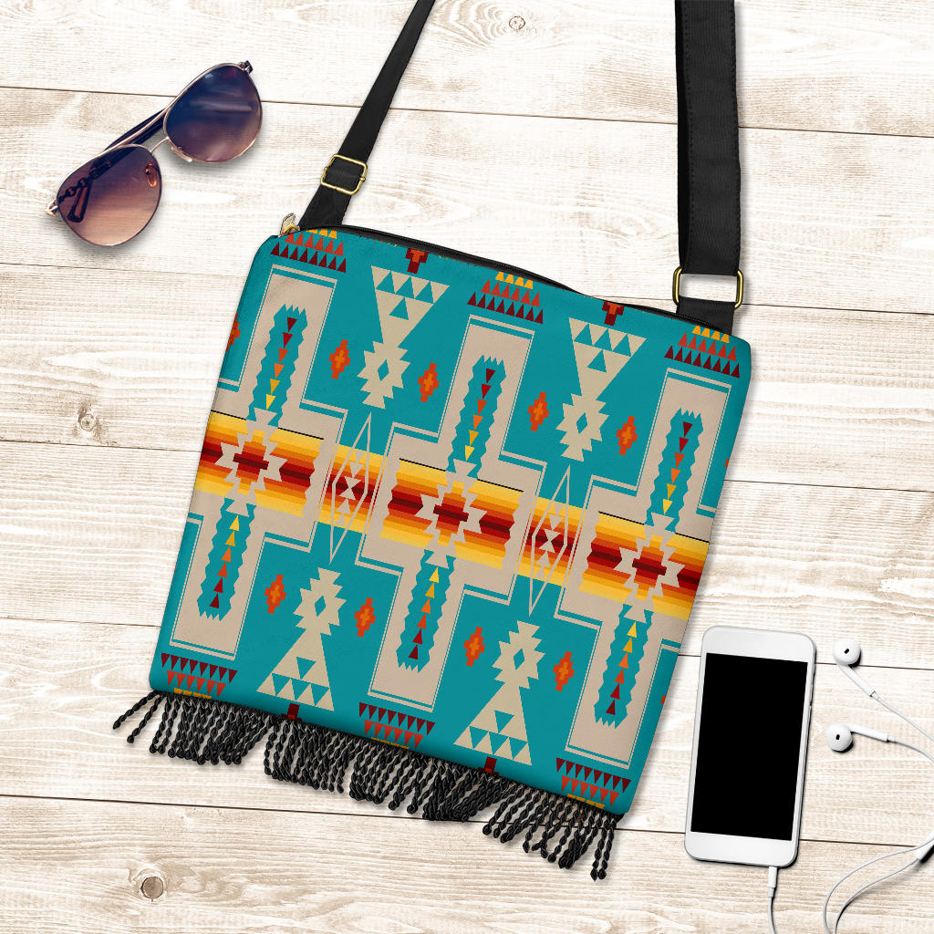 Turquoise crossbody-style tote with Native geometric design, black fringe trim, long strap