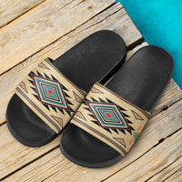Pair of slide sandals with black cushioned footbeds and beige Southwest patterned straps